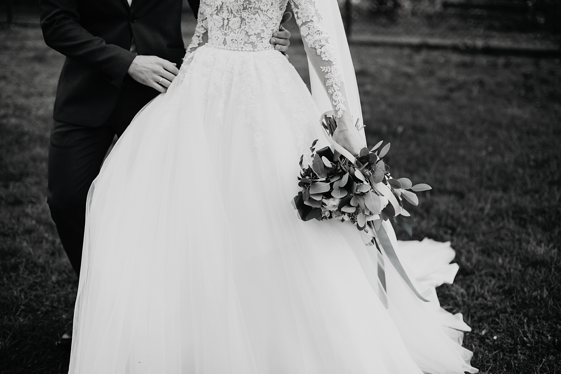 Stylish Happy Bride and Groom Walking in Yard and Holding Hands